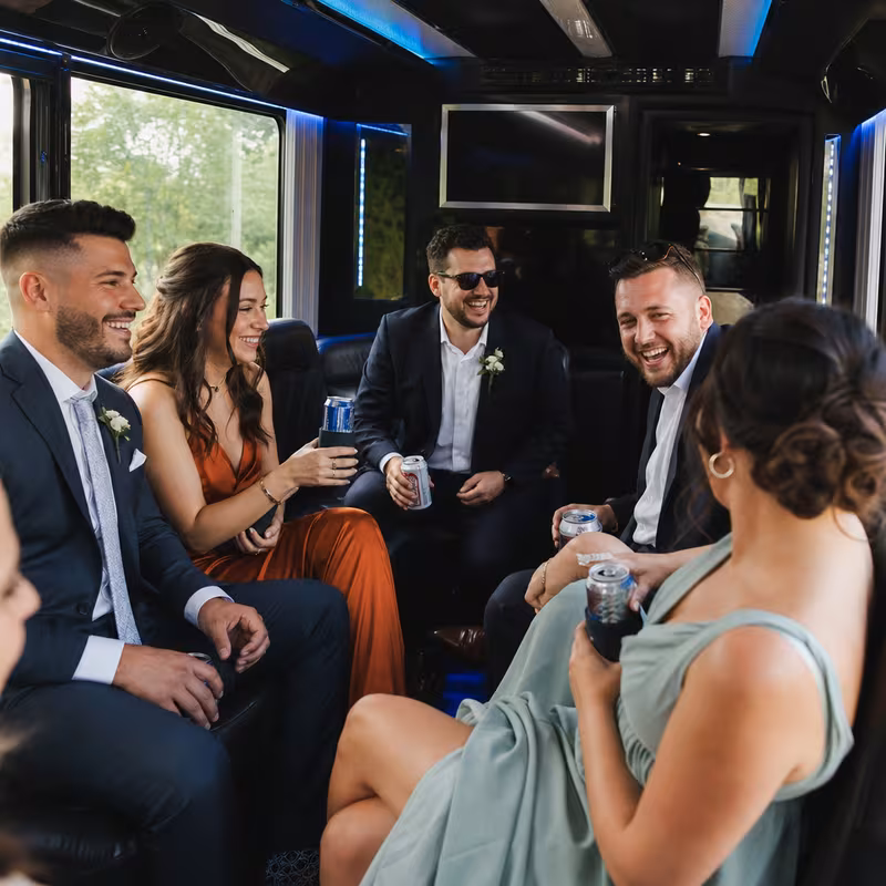 Wedding guests seated inside a Minneapolis party bus