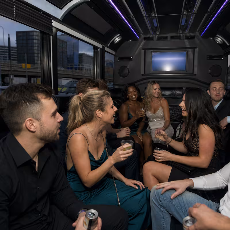 Party bus interior with wraparound leather seating and LED lighting in Minneapolis