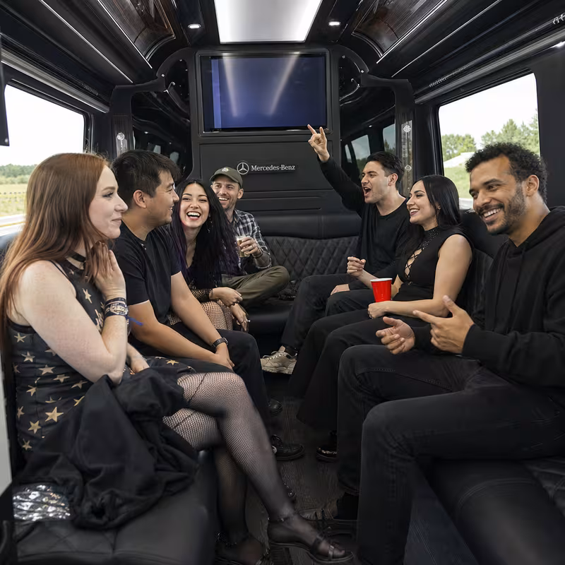Group boarding a white charter bus for Concert Transportation transportation in Minneapolis