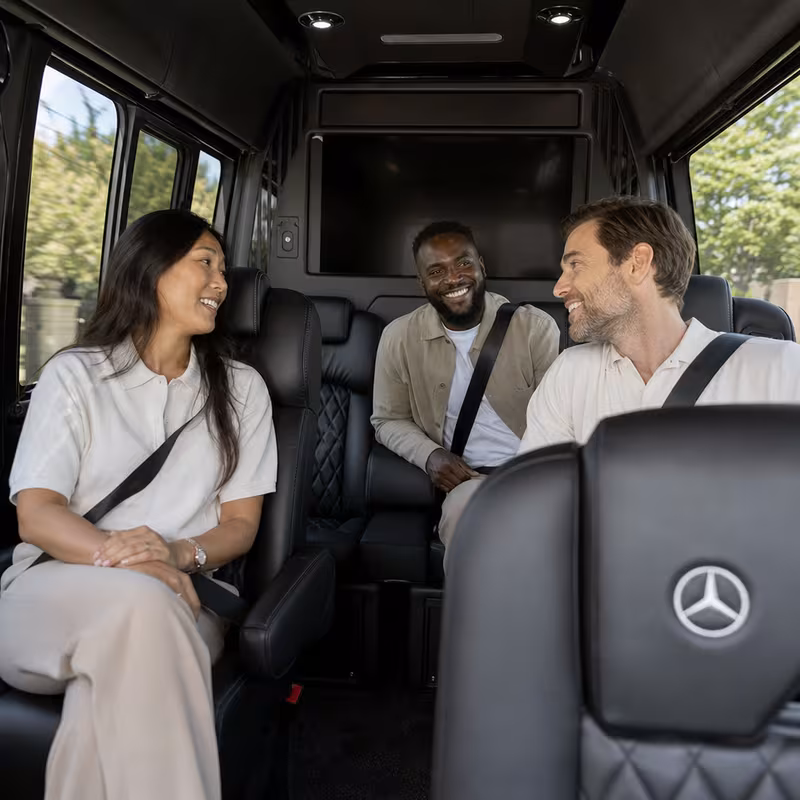 Group boarding a white charter bus for Corporate Transportation transportation in Minneapolis