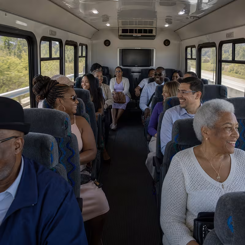 Group boarding a white charter bus for Private Event Transportation transportation in Minneapolis