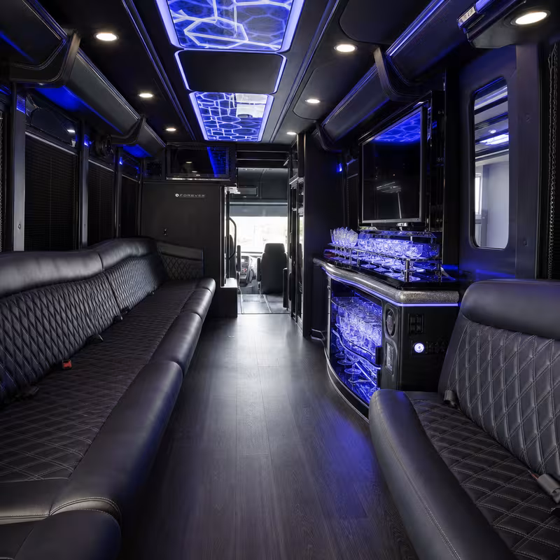 Party bus interior with wraparound leather seating and LED lighting in Minneapolis