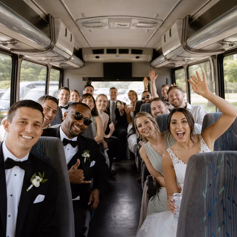 Group boarding a white charter bus for Wedding Transportation transportation in Minneapolis