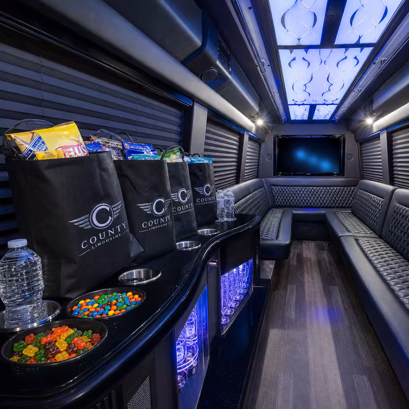 Party bus interior with wraparound leather seating and LED lighting in Minneapolis